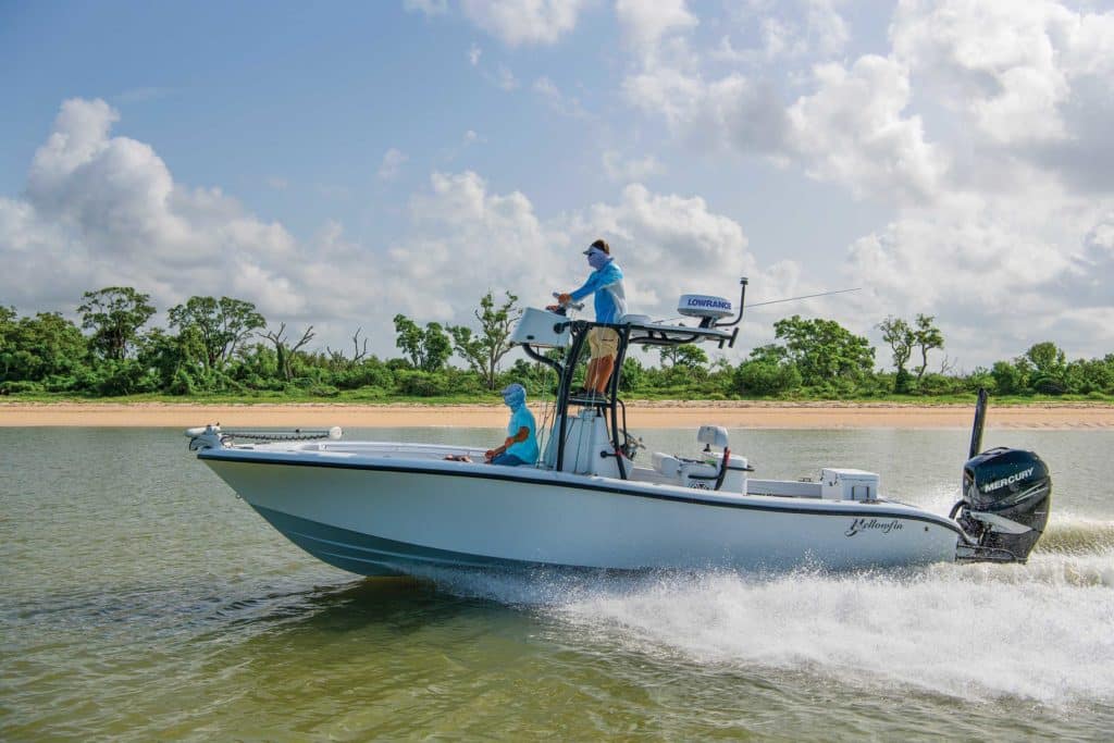 Yellowfin 26 Hybrid running along the shore