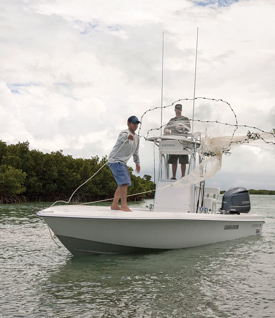 Throwing a cast net on a bay boat