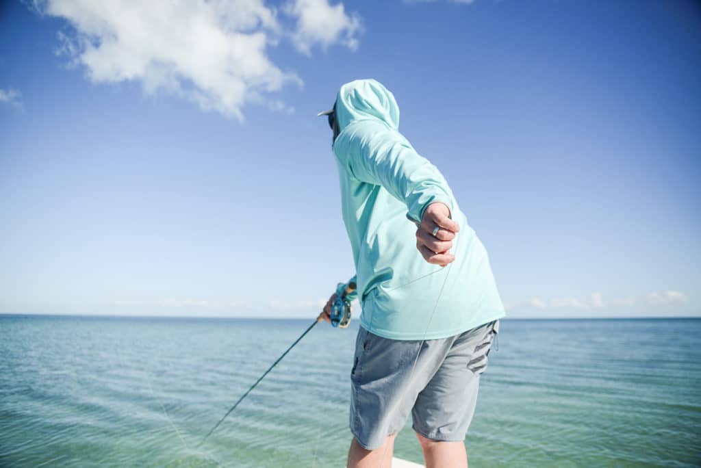 Fly fisherman trying to unfoul a fly