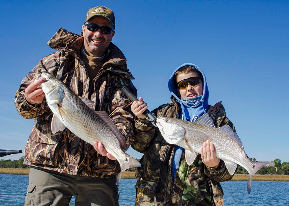 Holding up two redfish