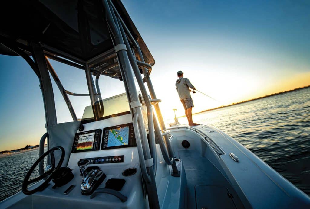 Fisherman on the bow using Humminbird electronics to locate fish