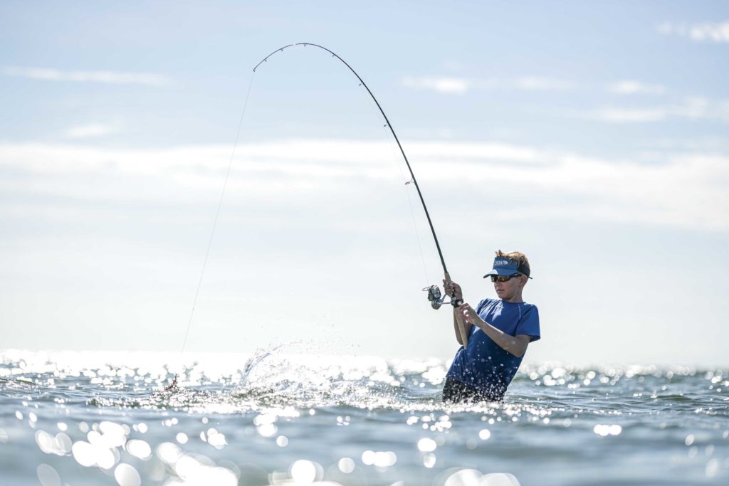 Wade fishing using a long fishing rod