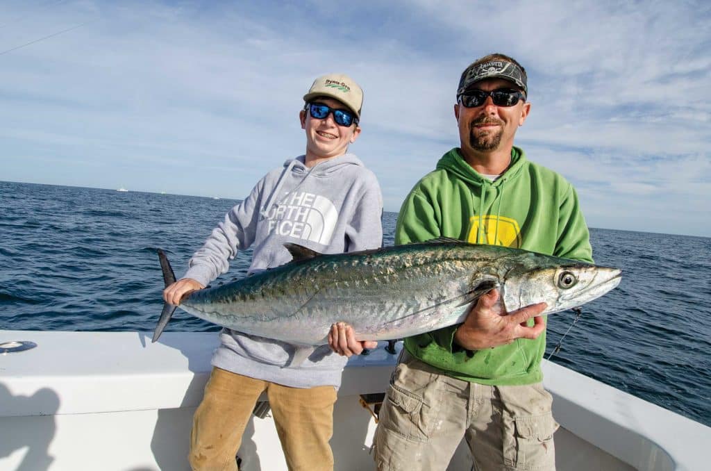 Anglers holding up a nice kingfish