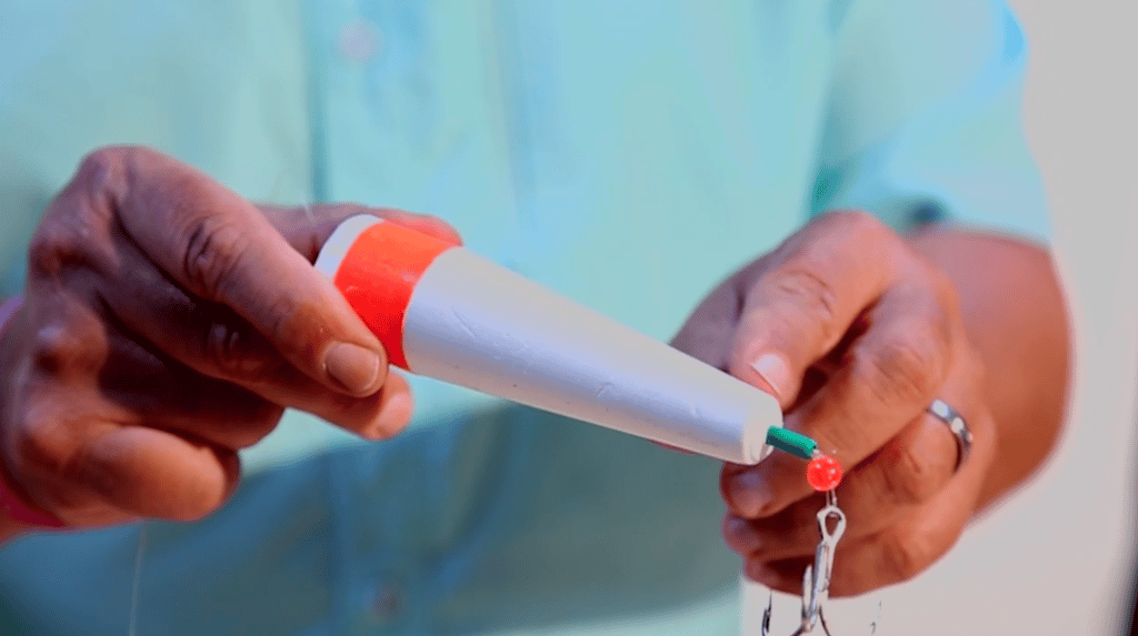 Angler rigging a popping cork