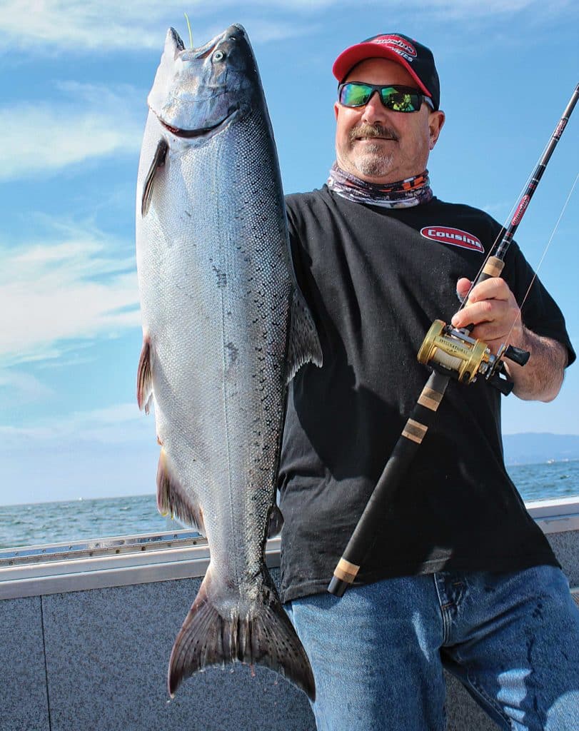 Angler holding up king salmon