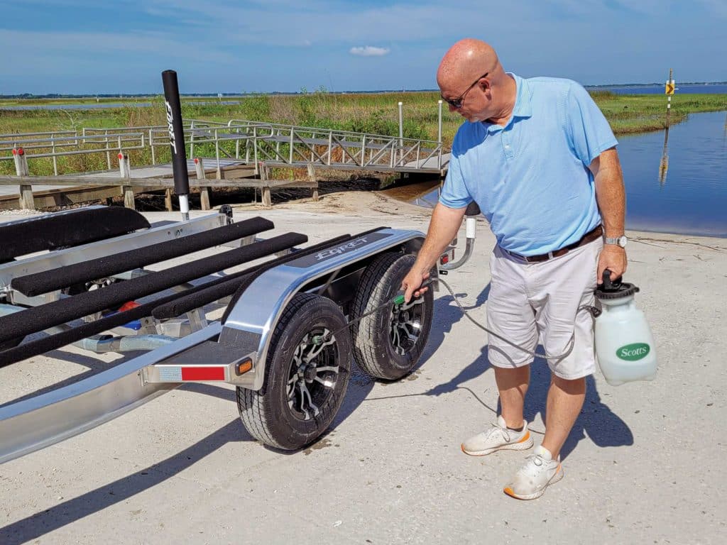 Boater spraying down trailer