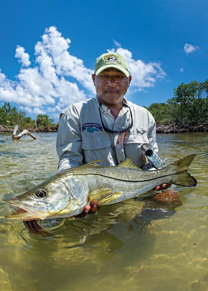 Fisherman holding snook