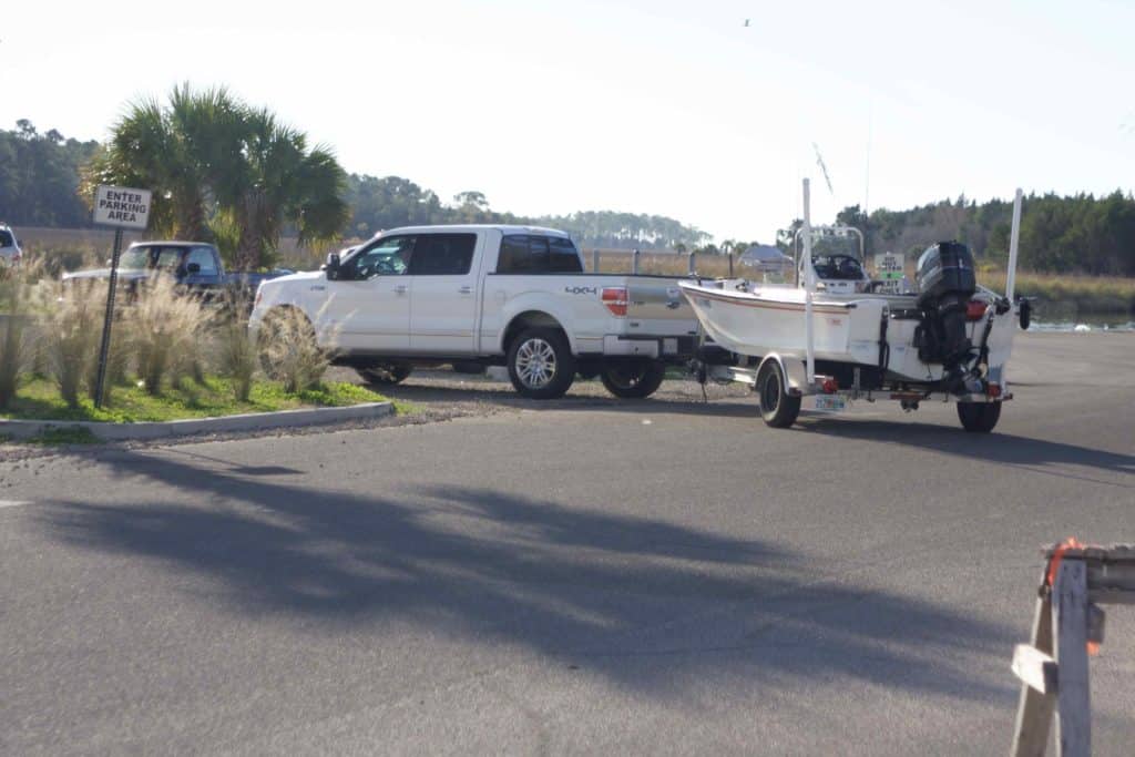 boat hooked to car on trailer