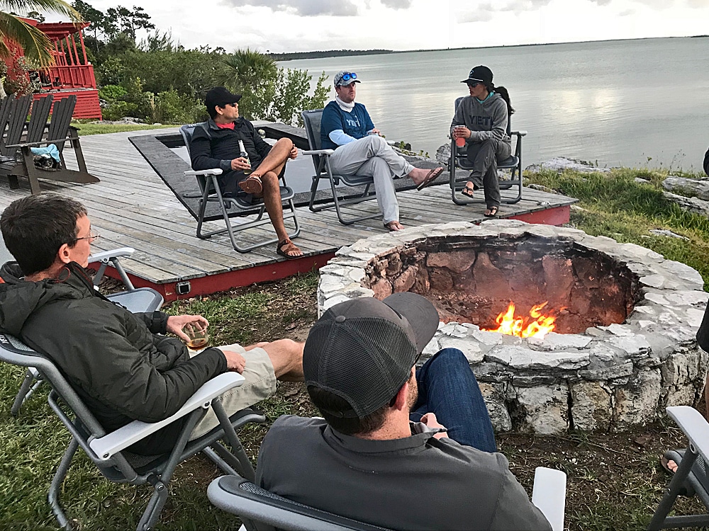 Anglers gather around the fire pit at Abaco Lodge