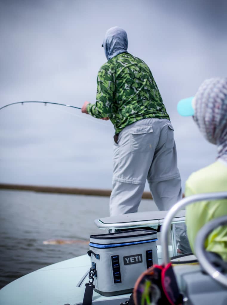 Fly angler locked in a tough battle with a bull redfish