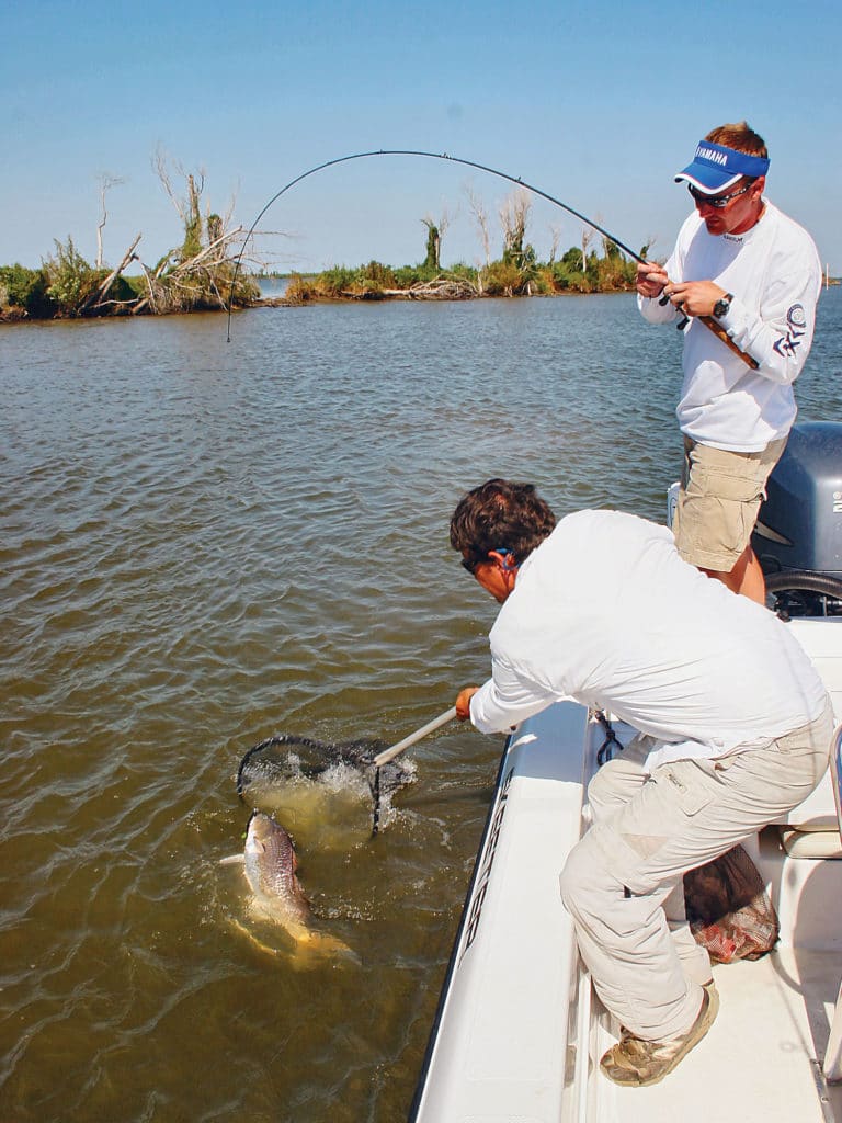 Look for open areas combined with submerged grass in water 2 to 3 feet deep. That’s where reds hold to ambush mullet and other bait.