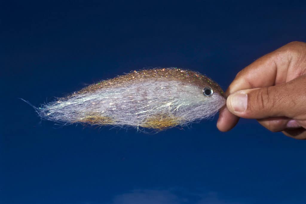 Bunker flies tied with synthetic fibers are tougher and don't soak up water, so they remain lighter and easier to throw.