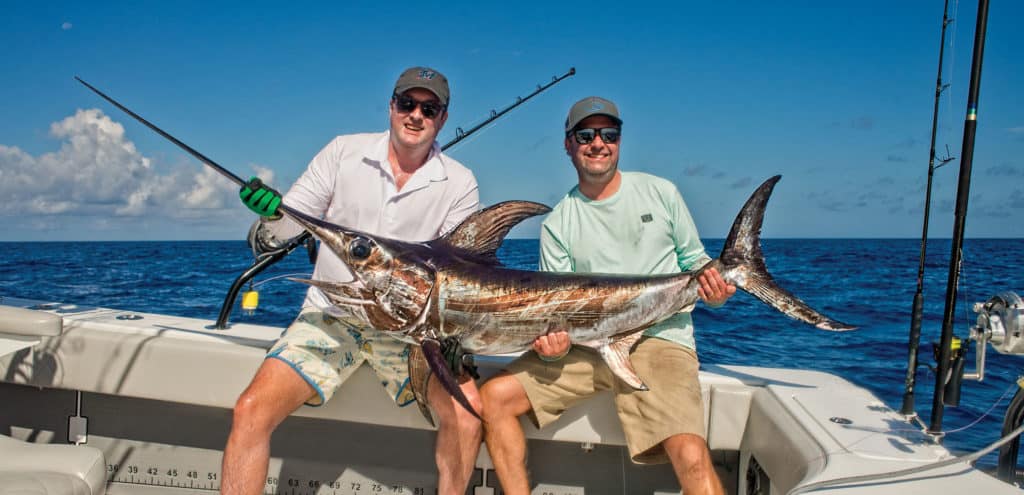Anglers holding up a swordfish
