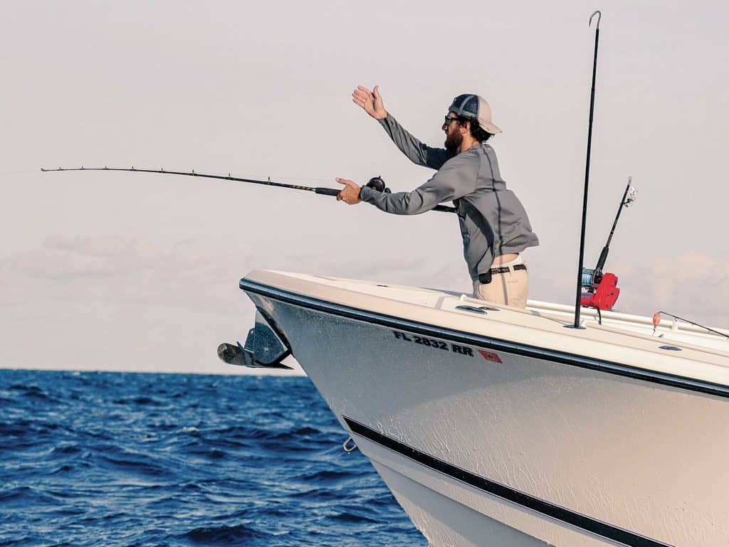 Angler guiding captain while fighting a big fish