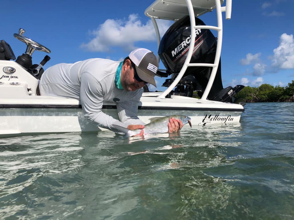 Bonefish next to flats skiff