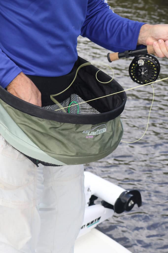 Angler using a stripping basket