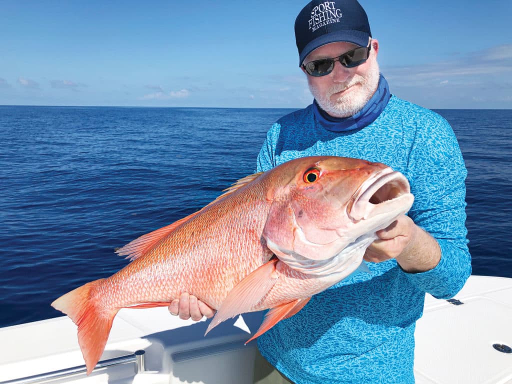Angler holding up red snapper