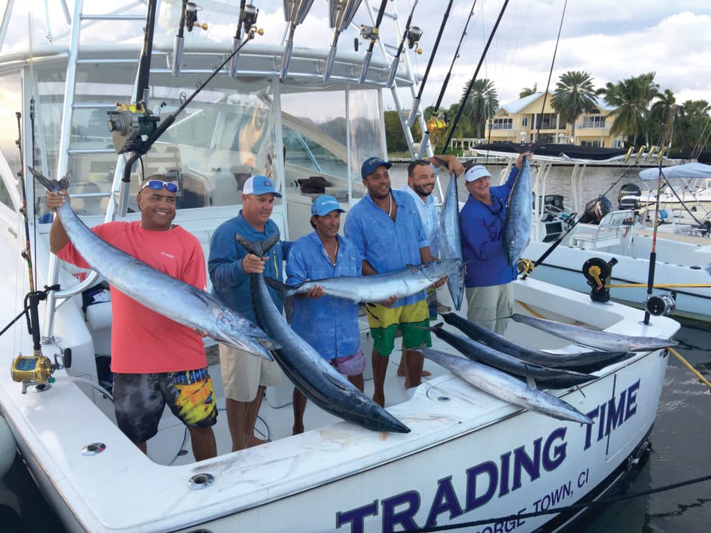 Fishing team holding up wahoo