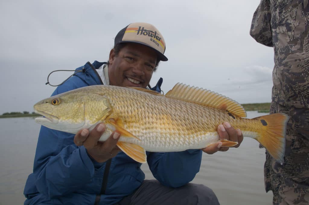 Large redfish held up by angler