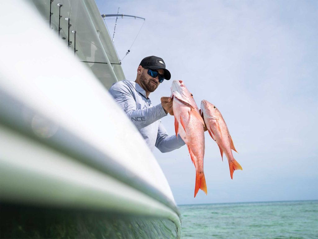 Two snapper being hauled in