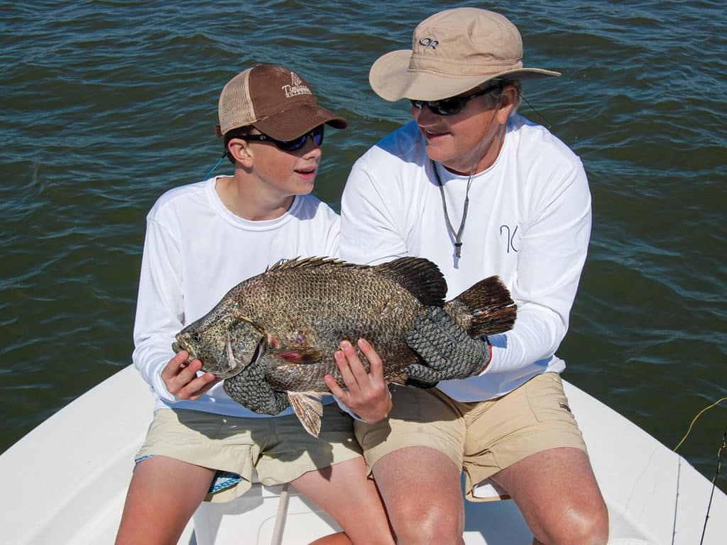Tripletail with two anglers