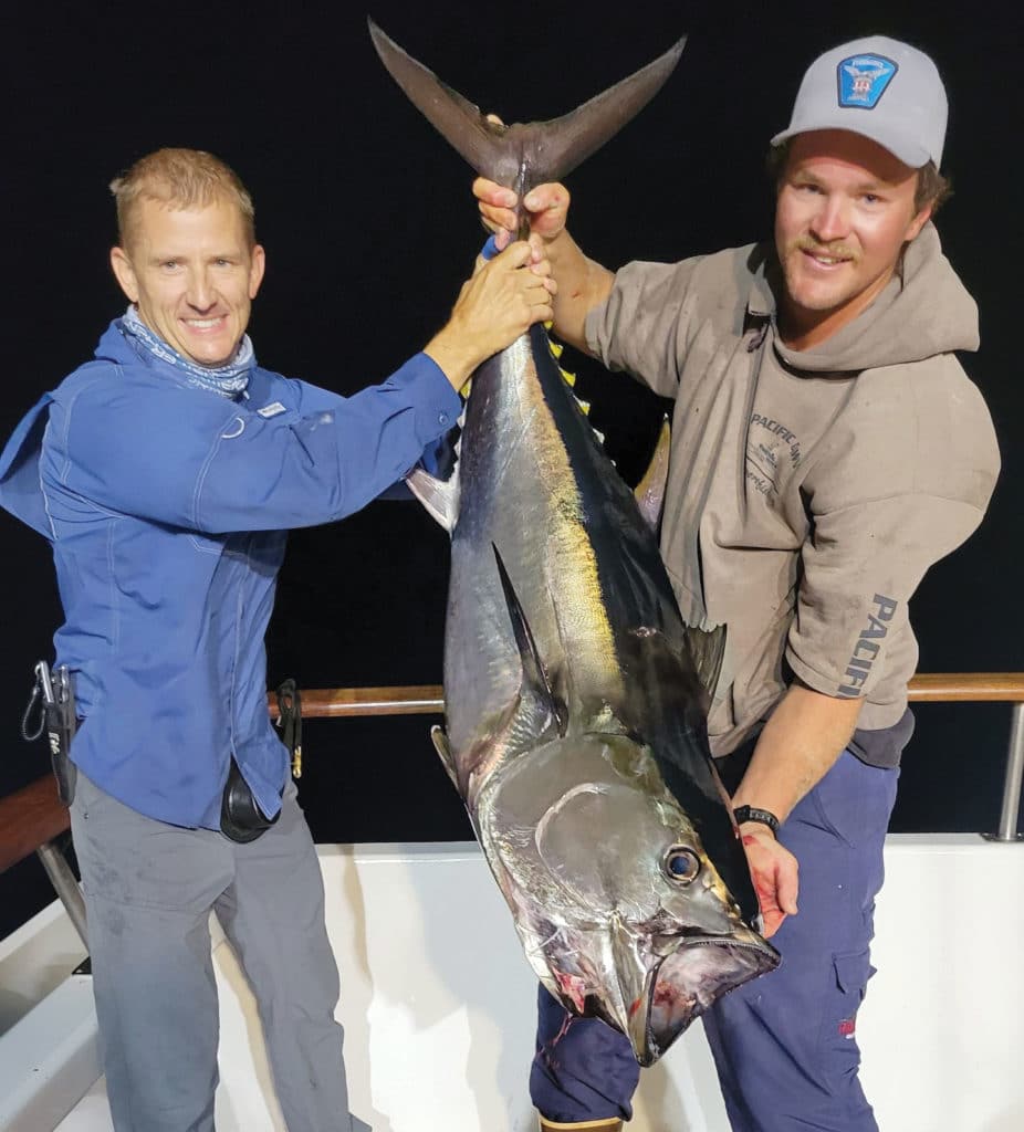 Anglers holding up bluefin tuna
