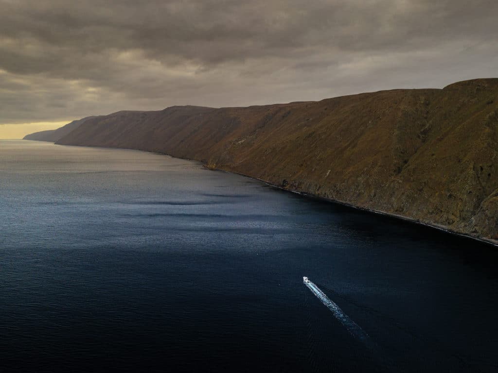 Boat running out at sunset