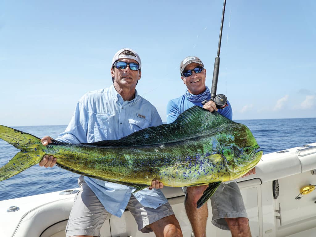 Anglers holding up a large mahi