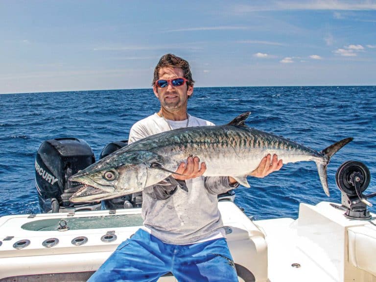 Angler holding kingfish