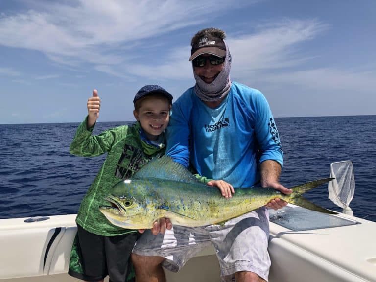 a pair of anglers with a mahi