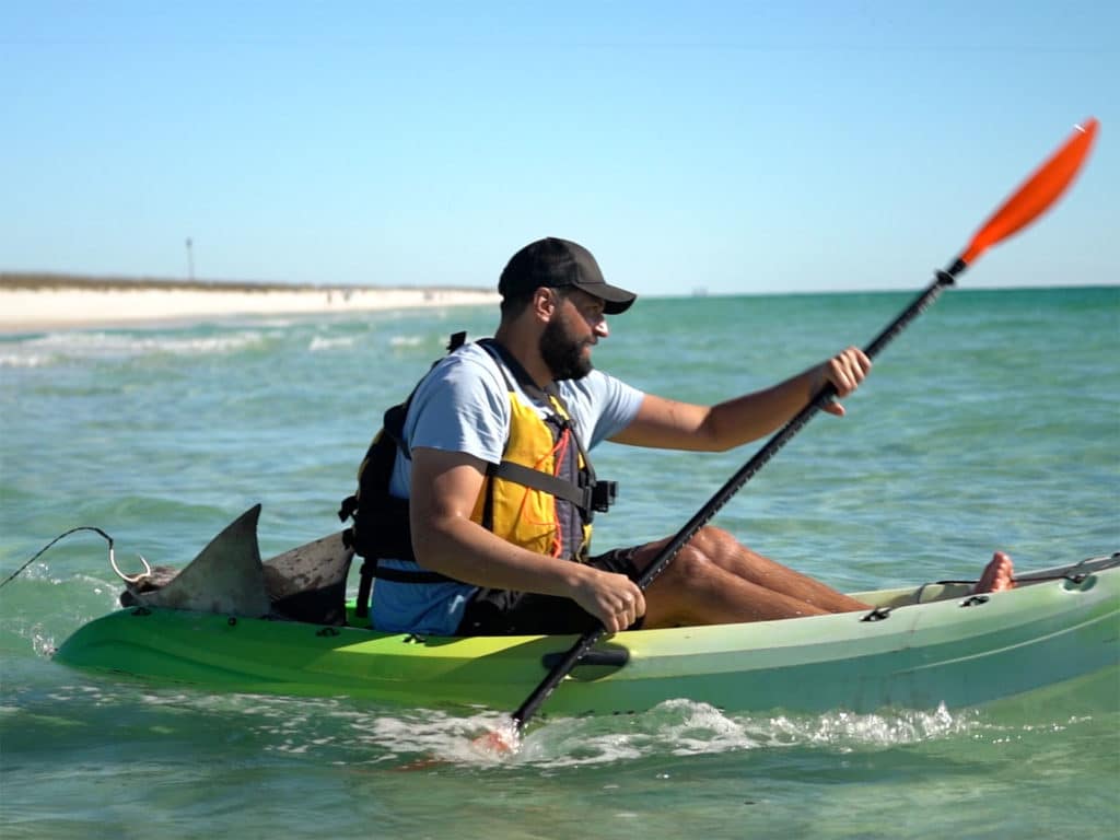 Deploying shark bait on a kayak