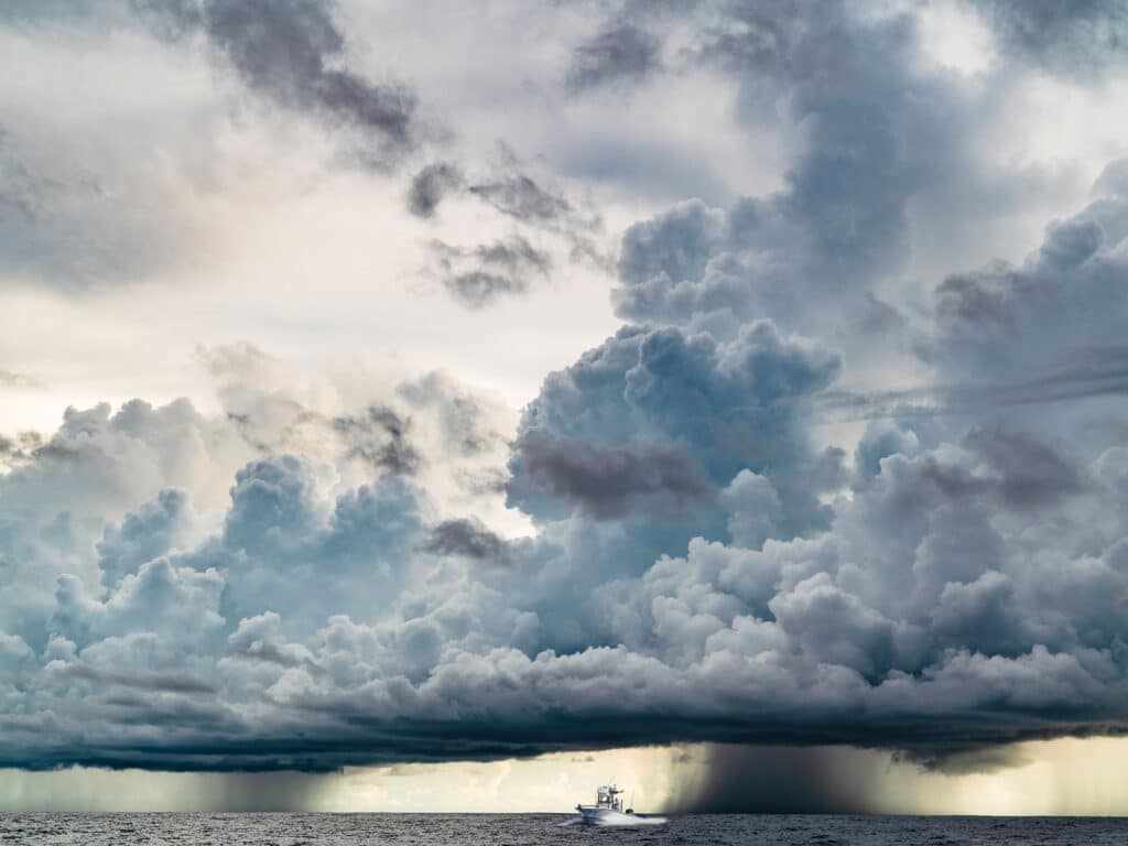 Boat offshore with storm approaching