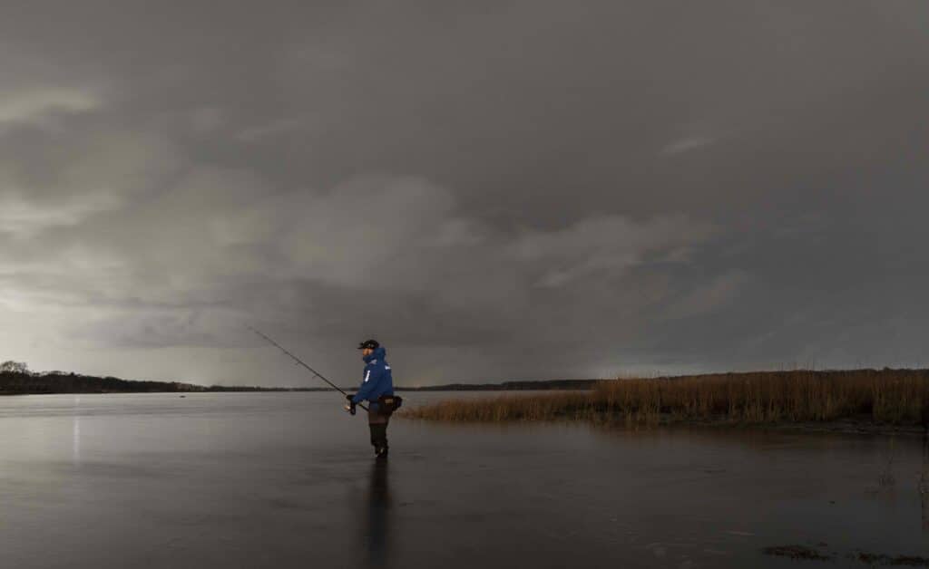 Angler wearing Simms Splash Cast Jacket