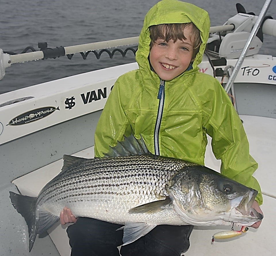 kid with striped bass