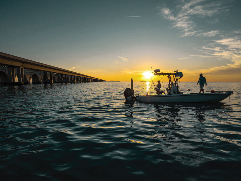 Fishing a bridge at sunset