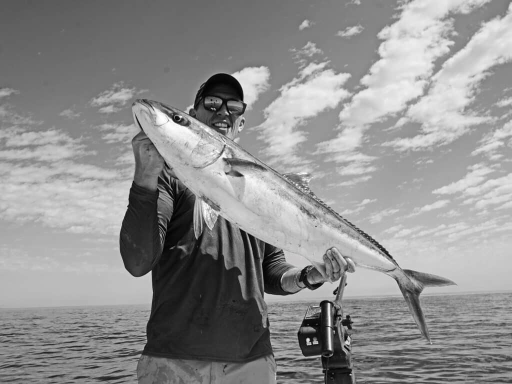 Angler holding up yellowtail