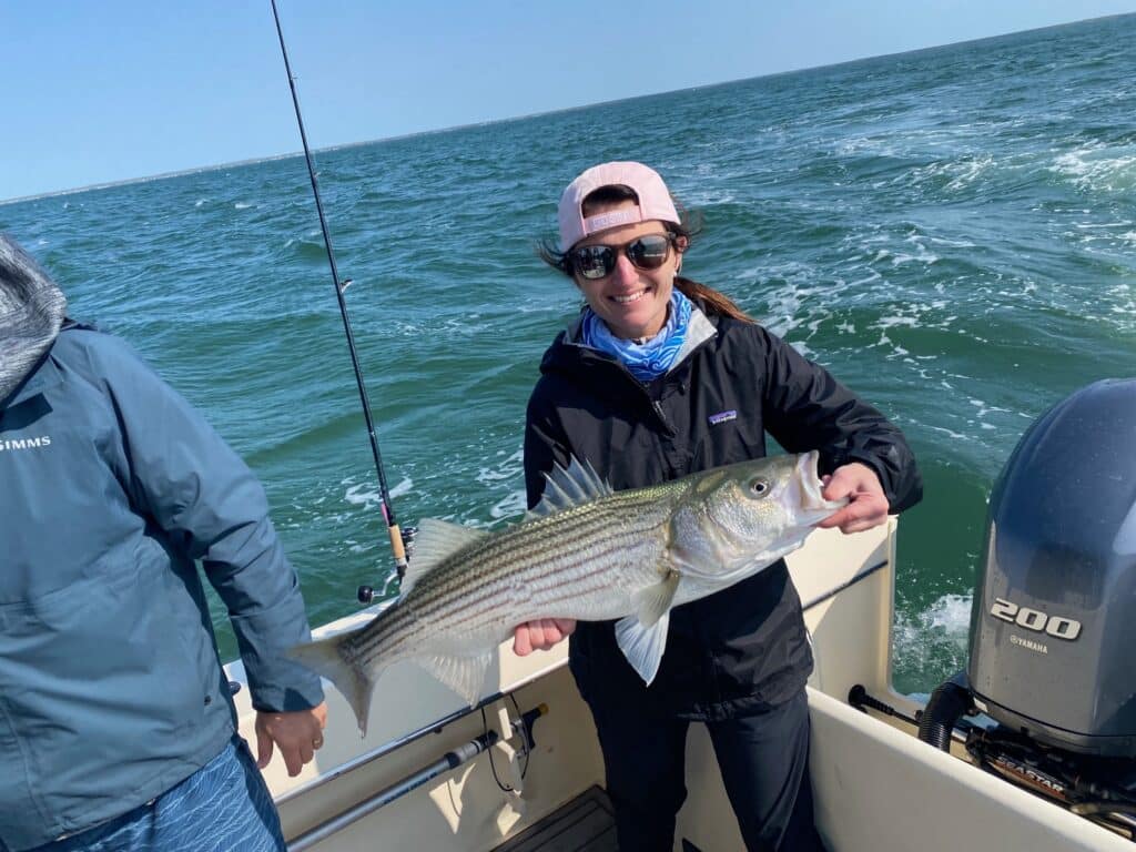 Costa Team Member with Striped Bass