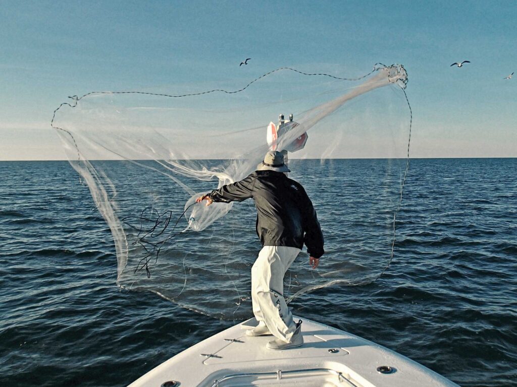 Throwing a castnet for baitfish