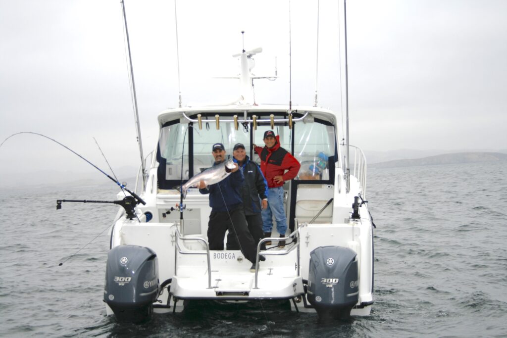 anglers with salmon on boat