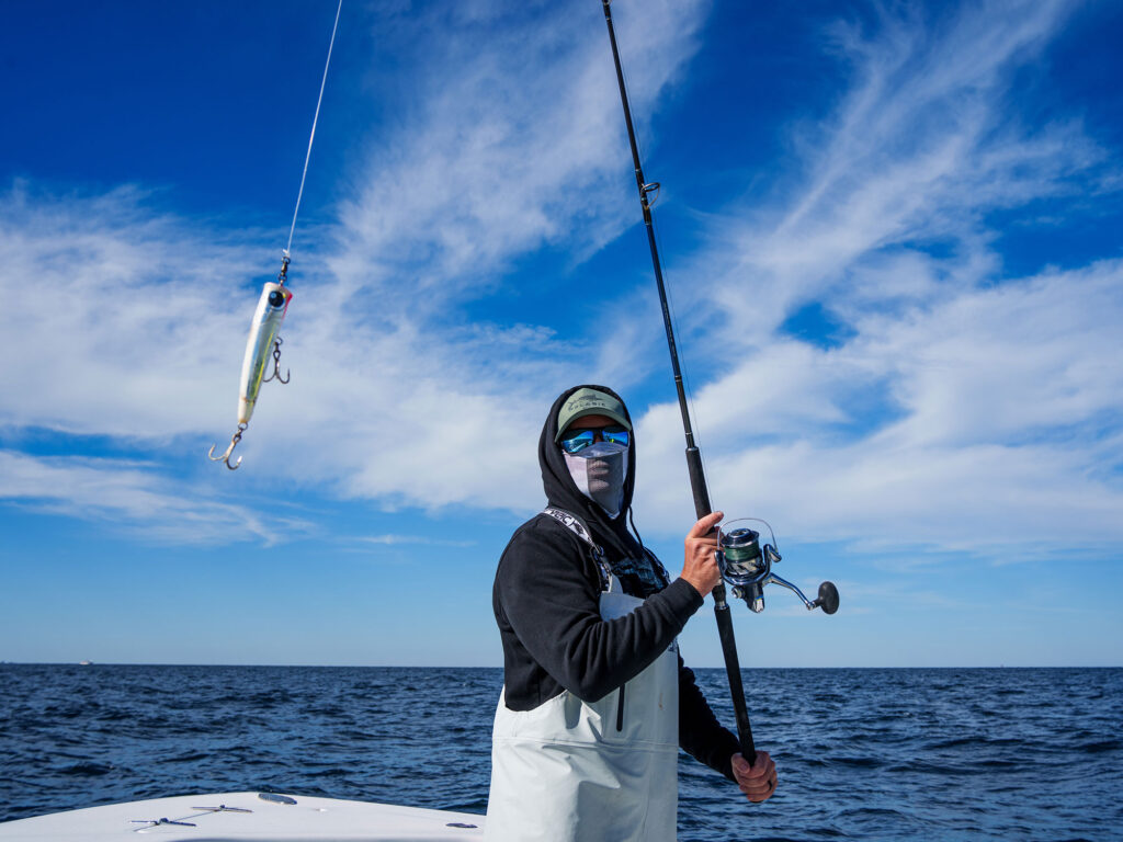 Angler casting a popper