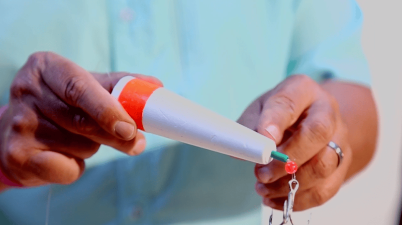 Angler rigging a popping cork