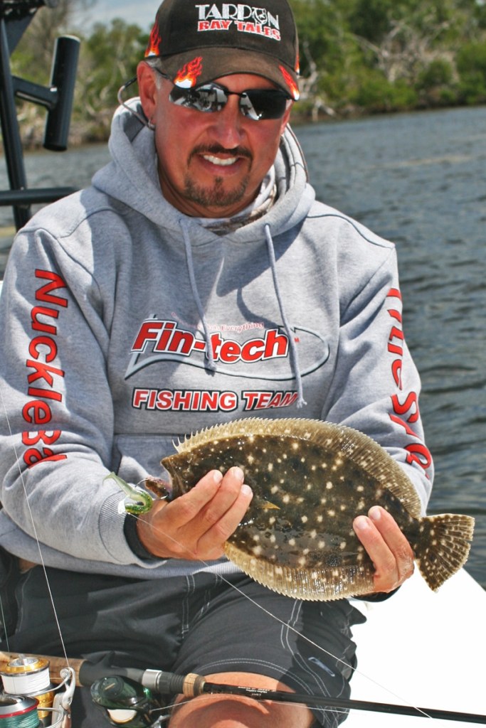 A flounder caught on a jig and a soft-plastic lure.