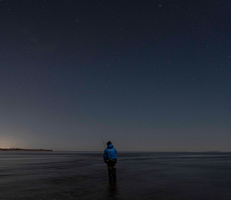 angler wearing Simms Splash Cast jacket