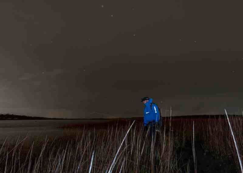 walking angler wearing Simms Splash Cast jacket