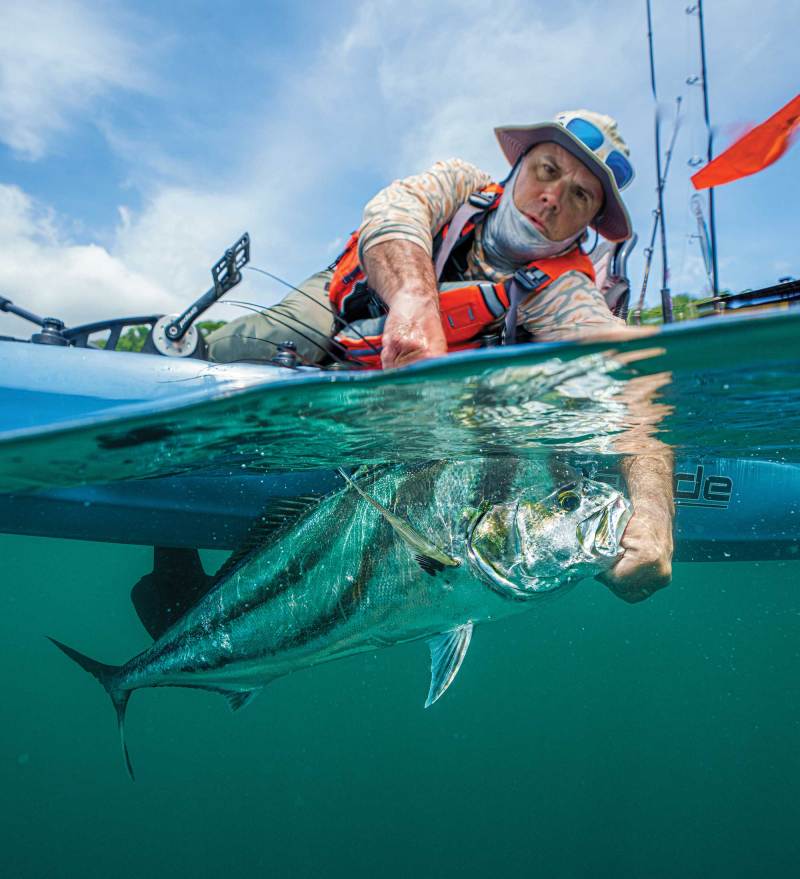 Angler catching a roosterfish from a kayak