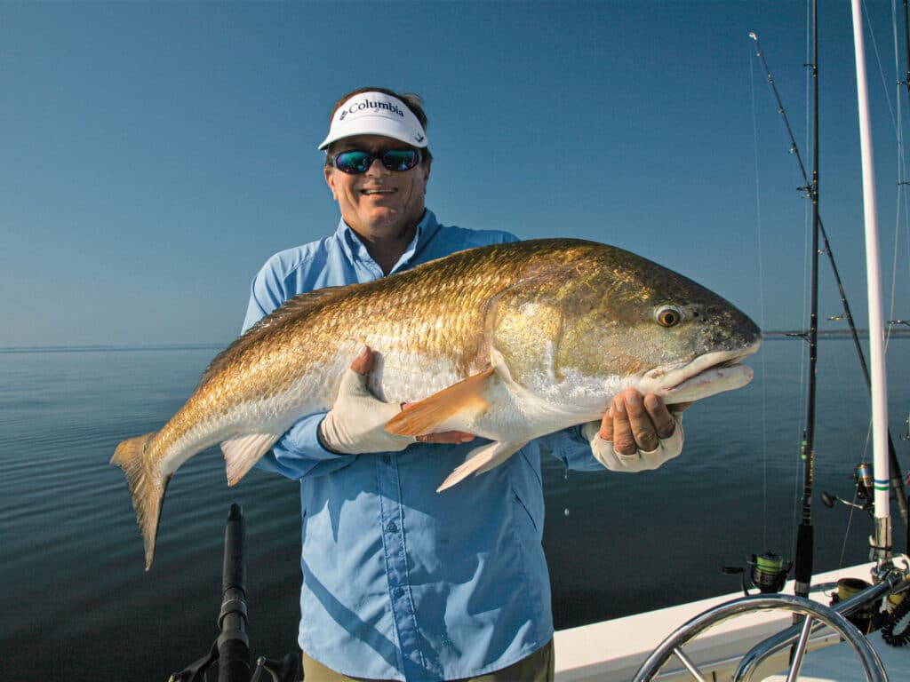 Angler holding a large redfish