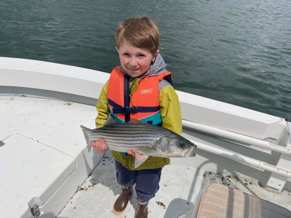 child with striped bass