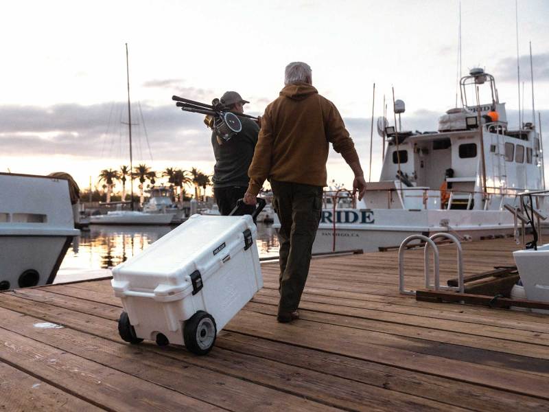 SWS225-Coolers-1 Anglers carrying cooler down dock