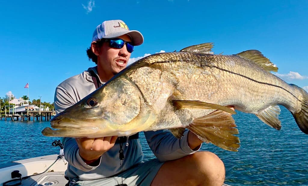 Aaron Benzrihem holding a snook