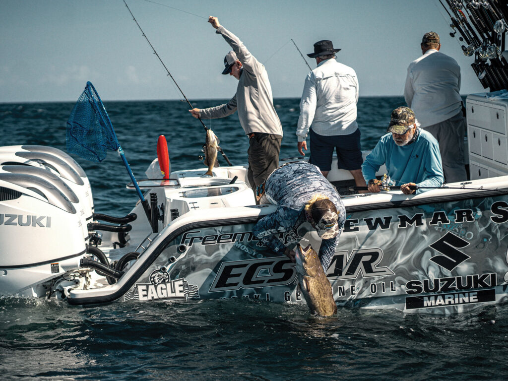 Angler reeling in a gag grouper